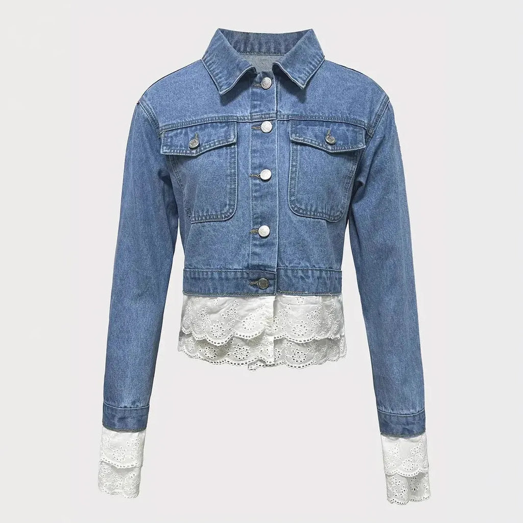 Blue women's denim jacket with lace stitching on the front, shown on a hanger.