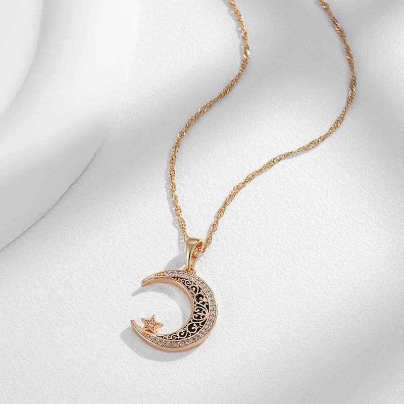 Rose gold star moon pendant necklace with zircon and enamel details on adjustable water wave chain