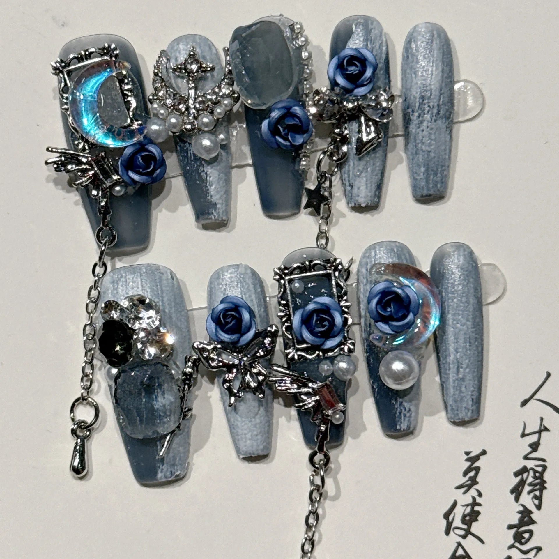 Heavy industry night blue gel nail wraps with ornate rose and tulip floral patterns for an evening manicure.