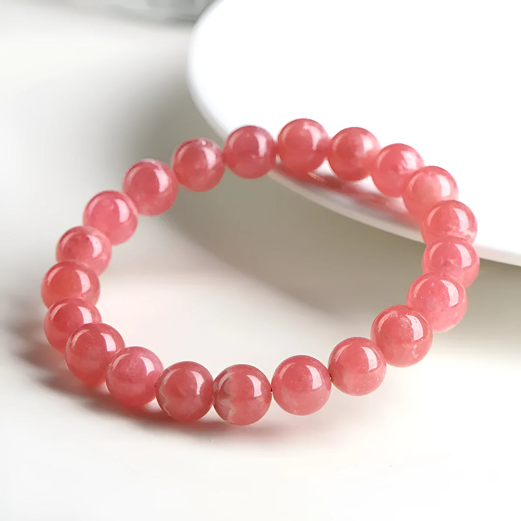Women's geometric crystal bracelet with longevity lock in natural red rhodochrosite patterns showing angular bead shapes