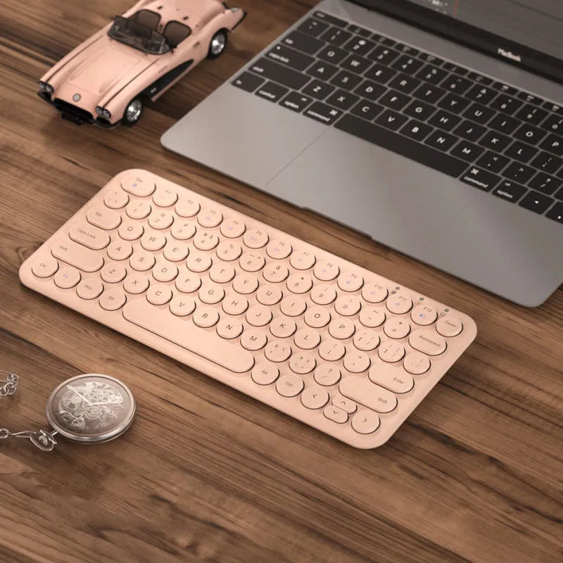 Mute ultra-thin wireless keyboard and mouse set in pink on a desk with USB receiver.