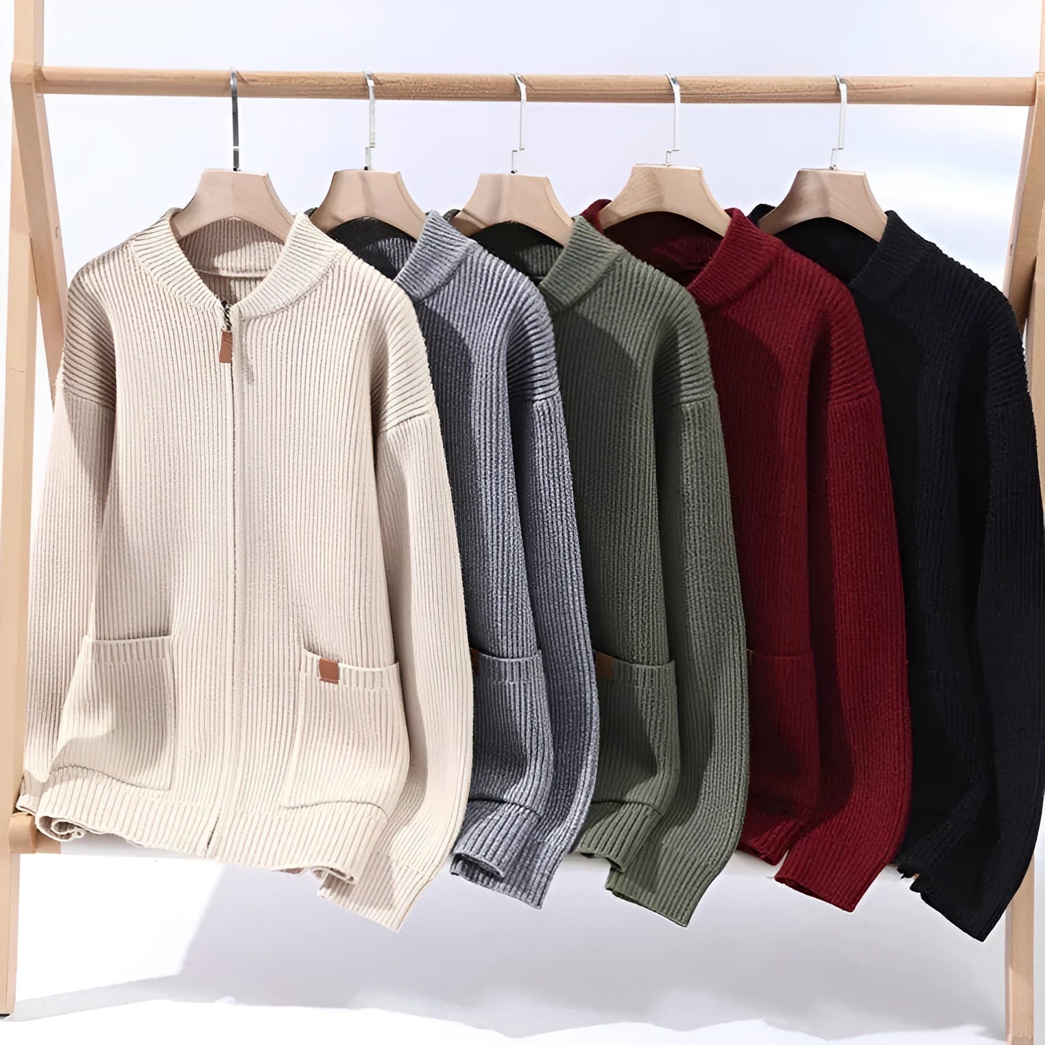 Men's striped sweater cardigan jacket in beige, grey, black, red, or green colour options on a hanger.