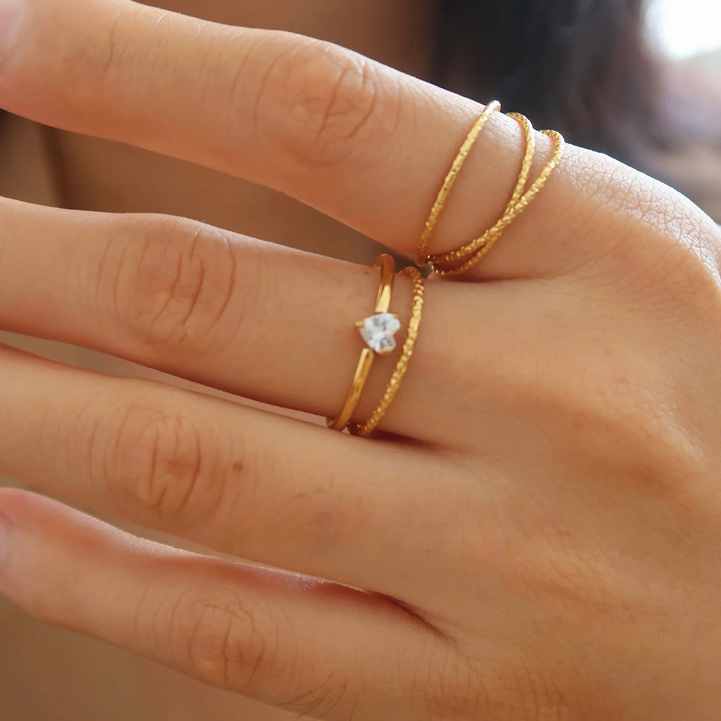 Golden electroplated stainless steel ring in love heart and oval shapes for women.