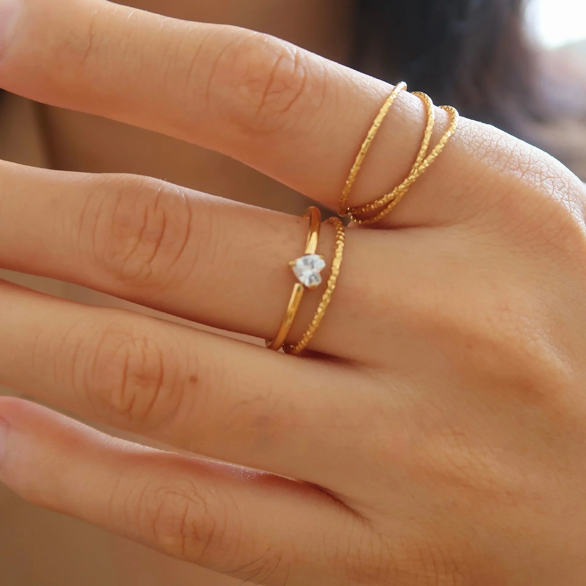 Golden electroplated stainless steel ring in love heart and oval shapes for women.