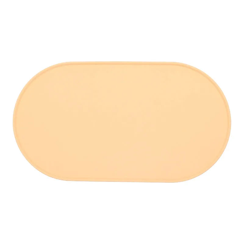 Silicone waterproof cat feeding placemat with non-slip base in beige colour on a wooden floor.
