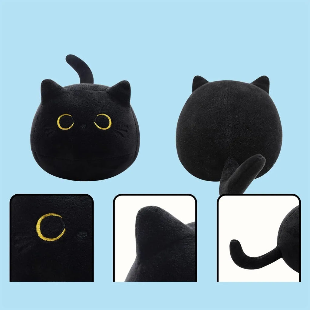Black fluffy cat plush toy stuffed animal on a sofa, used as a soft cushion.