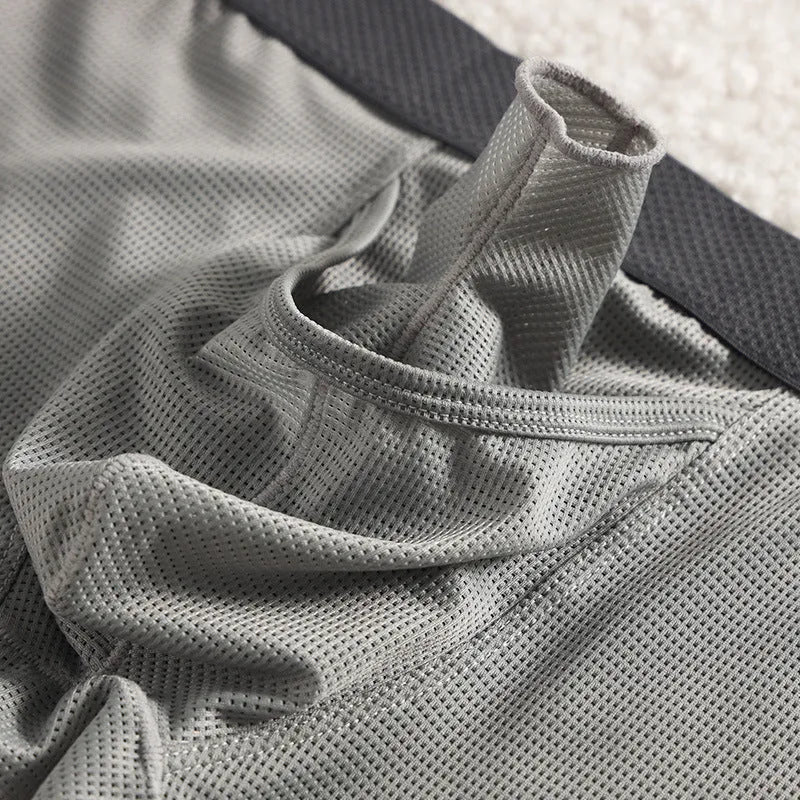 Men's solid colour Ice Silk nylon boxer underwear with mesh breathable fabric in black, grey, or white.