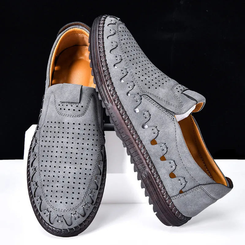 Men's brown casual slip-on leather shoes with round toe and flat sole on a white background.