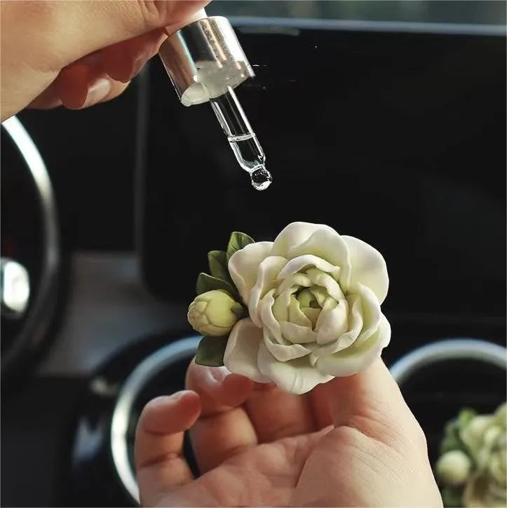 Jasmine-scented car air freshener with gypsum base clipped to vehicle vent
