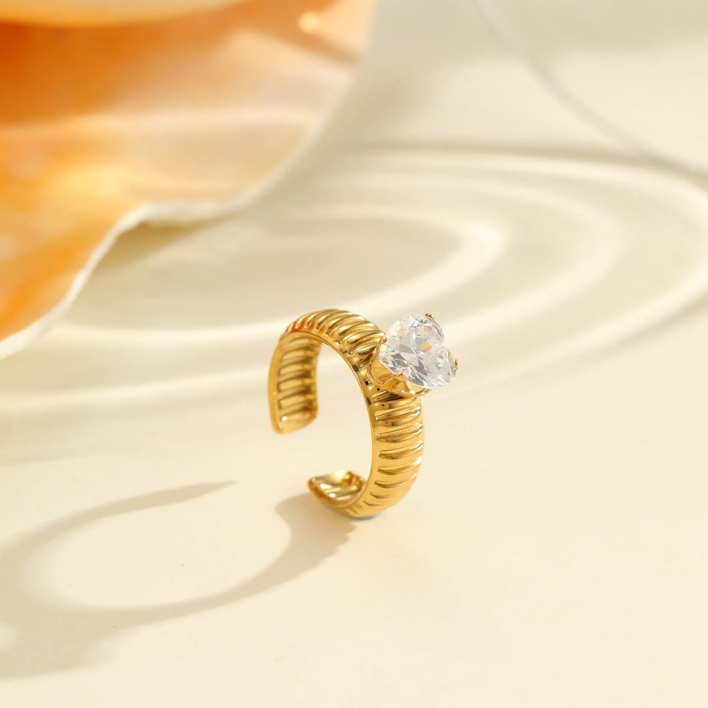 Gold electroplated stainless steel ring with geometric heart shape and inlaid zircon stones, open mouth adjustable design.