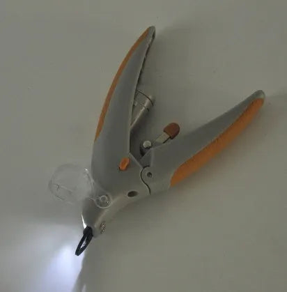 LED illuminated dog nail trimmer with transparent plastic blade guard showing blood line indicator