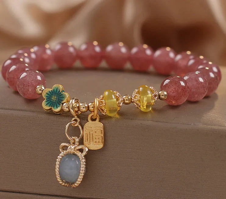 Red women's bracelet with strawberry quartz beads, alloy metal, and rhinestone detailing