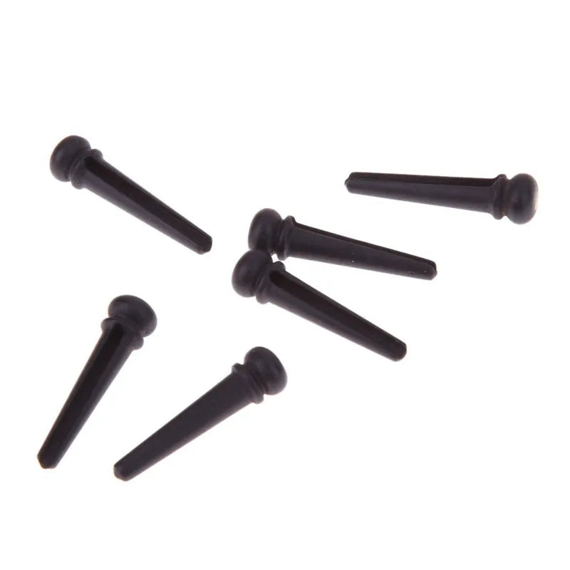 Six ebony folk guitar string nails with 5.3mm bayonet diameter and matt black finish