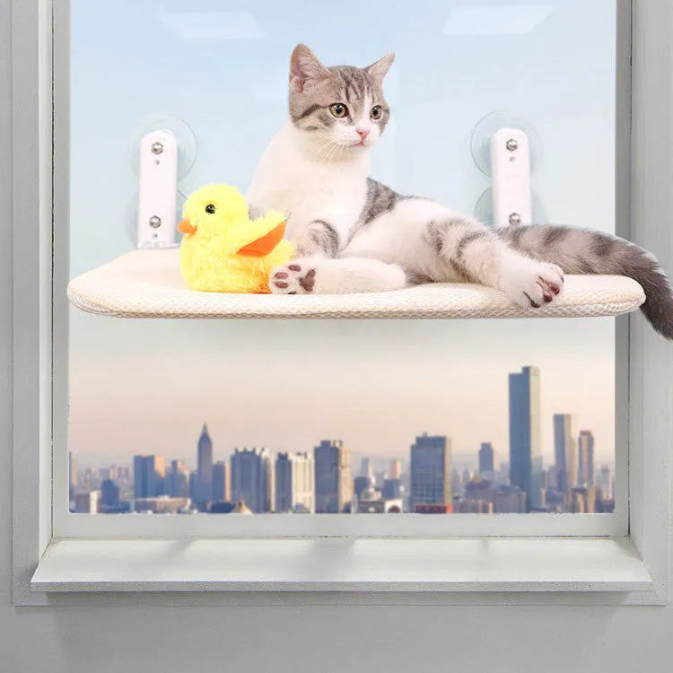 Foldable cat hammock with stainless steel suction cups attached to a window, shown in beige mesh.