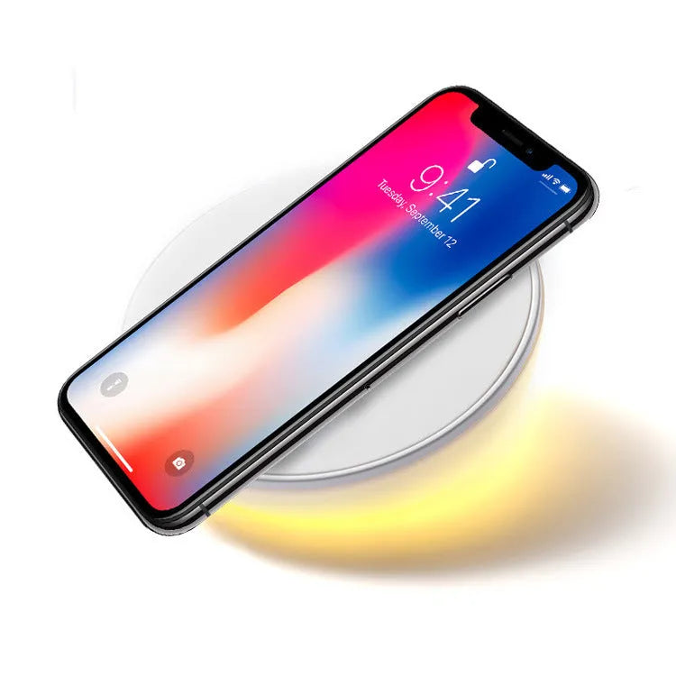 White wireless charging pad with clock display and alarm functions for smartphone bedside charging
