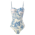 Women's patterned blue one-piece swimsuit with matching gauze skirt accessory