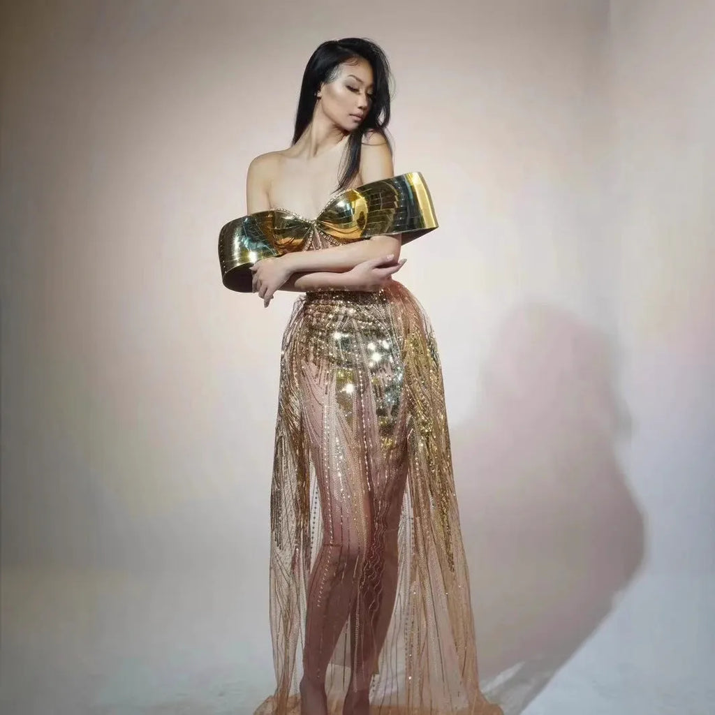 Gold strapless sequin evening dress with a voluminous tulle skirt and a high thigh split.