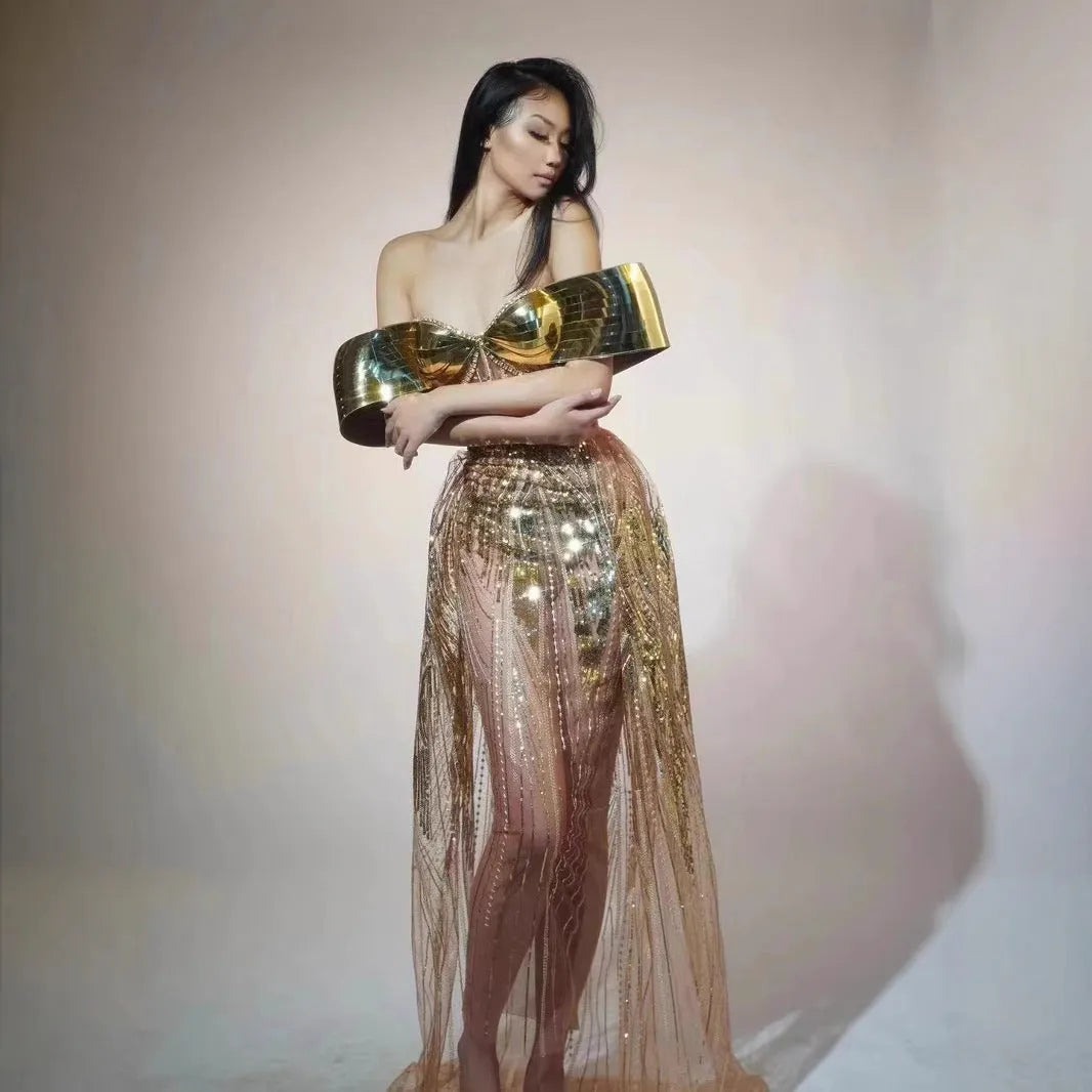Gold strapless sequin evening dress with a voluminous tulle skirt and a high thigh split.