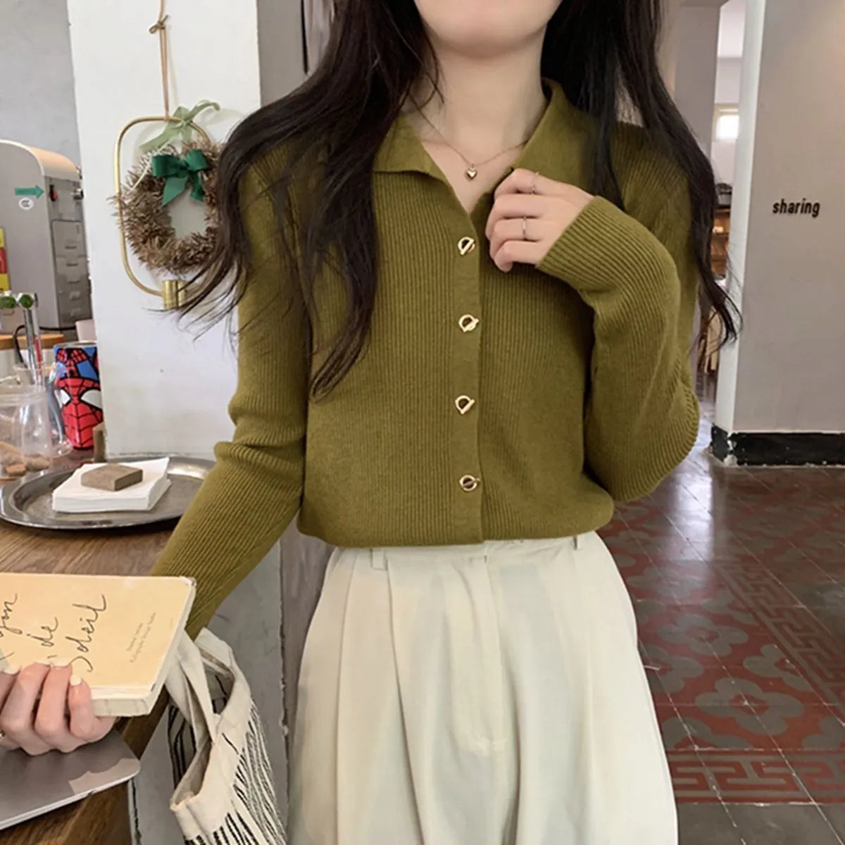 Women's beige loose-fit viscose knitted cardigan top with long sleeves shown worn open.