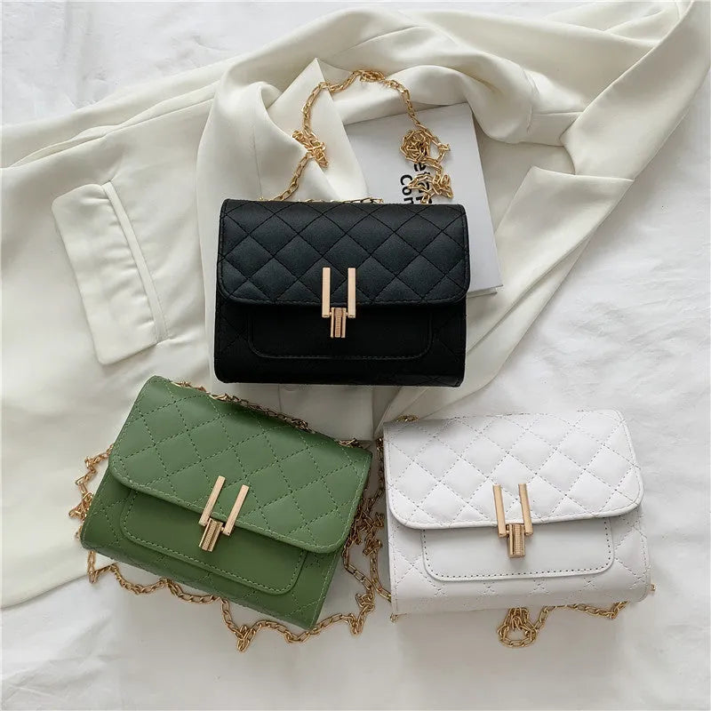 Women's solid colour crossbody bag with diamond lattice chain strap in black, shown from the front.