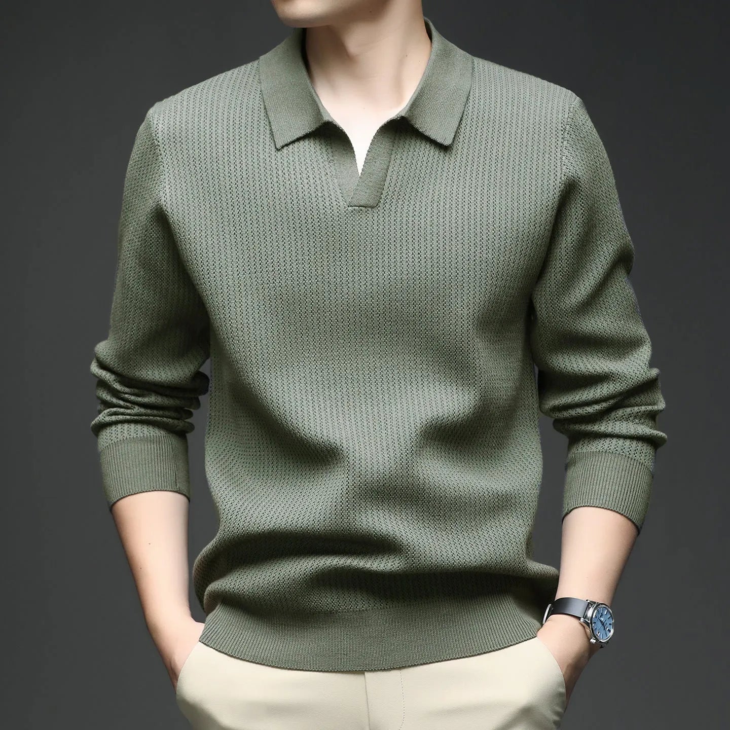 Men's loose green pullover sweater for casual autumn wear on a hanger