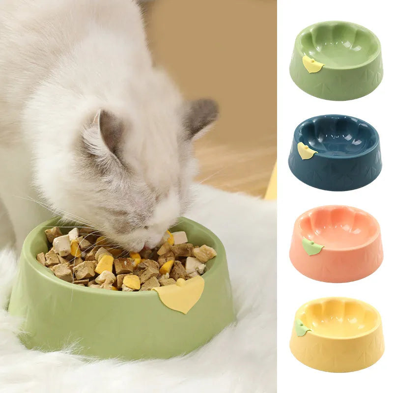 Green plastic double pet bowl with flower-shaped base for cat or small dog food and water.