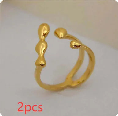 Brass opening ring with spherical elements in gold or silver finish