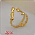 Brass opening ring with spherical elements in gold or silver finish
