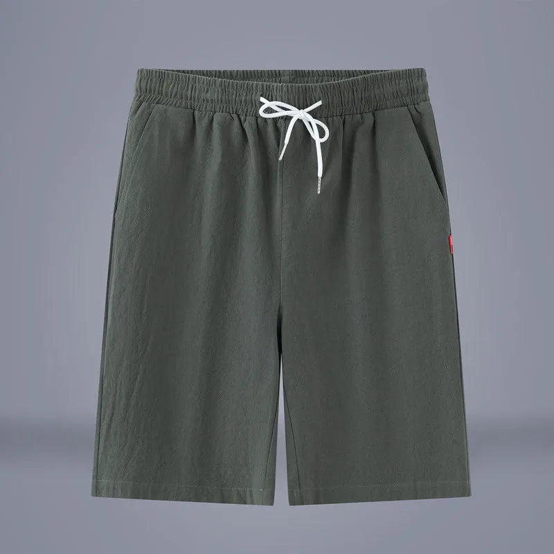 Man wearing solid colour cotton linen cropped trousers with a drawstring waist in a casual setting.