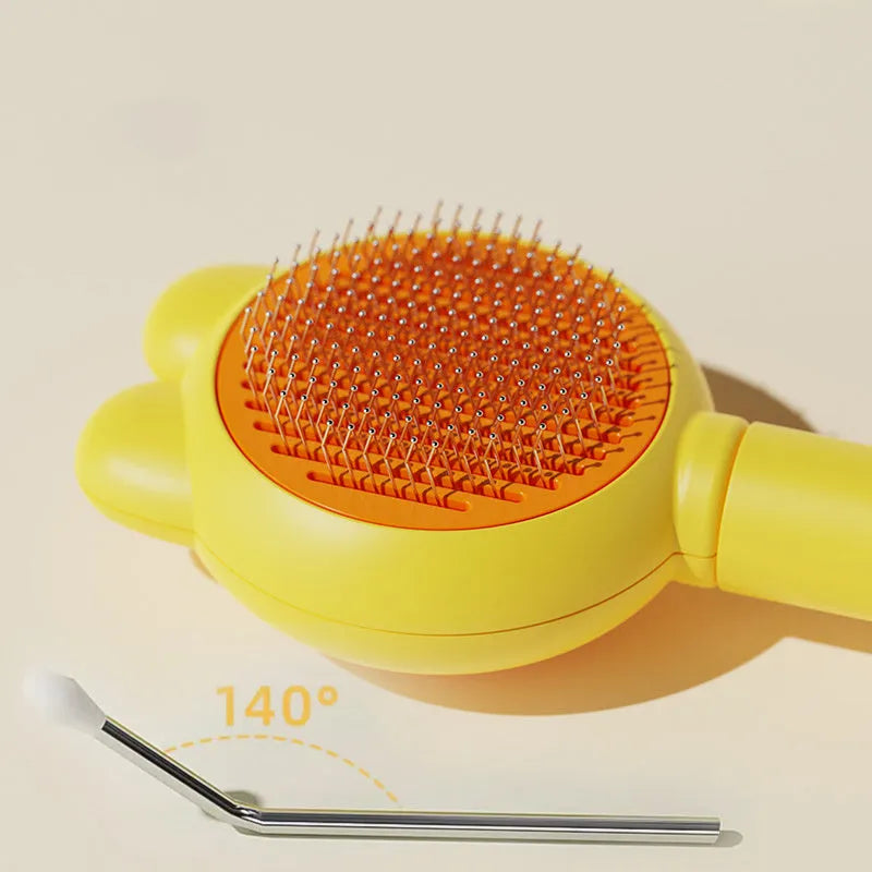 Self-cleaning pet brush with release button showing stainless steel comb teeth and coloured handle