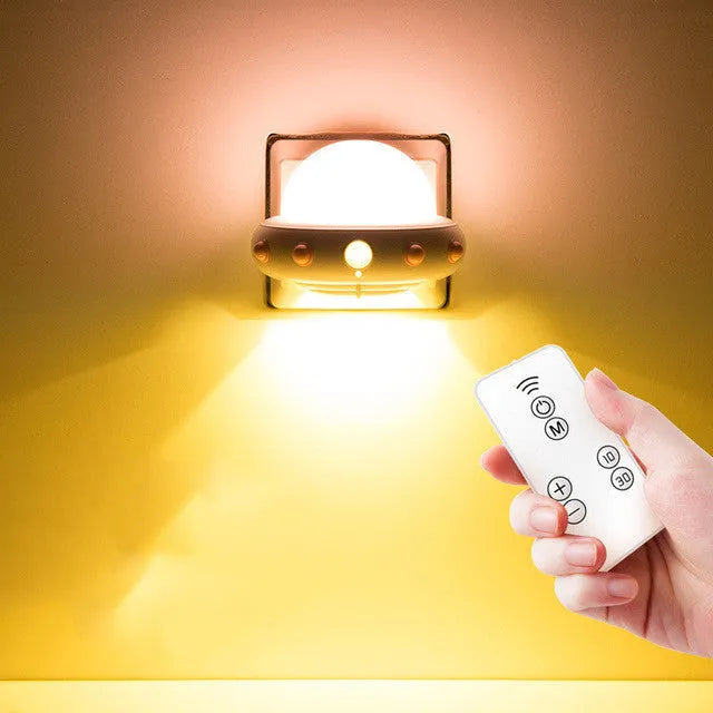 Remote control UFO shaped bedside night light in blue, pink, or white colour options.