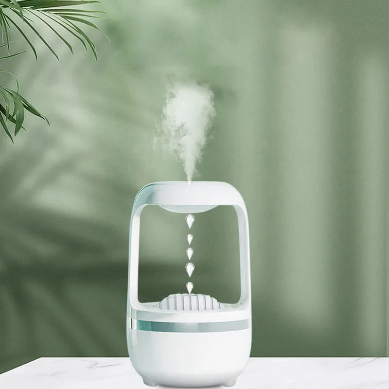White anti-gravity humidifier with upward-flowing water droplets on a desk