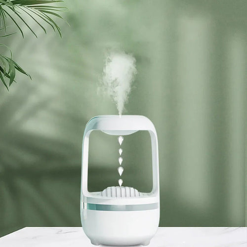 White anti-gravity humidifier with upward-flowing water droplets on a desk
