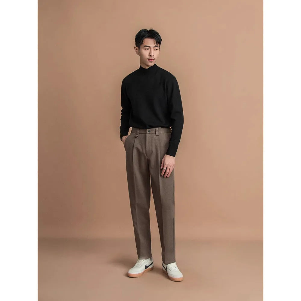 Men's straight leg casual pants in black with a draped fit, shown on a hanger.