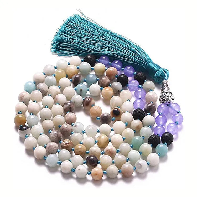 Geometric agate pendant necklace with colourful stone pattern and tassel detail on model