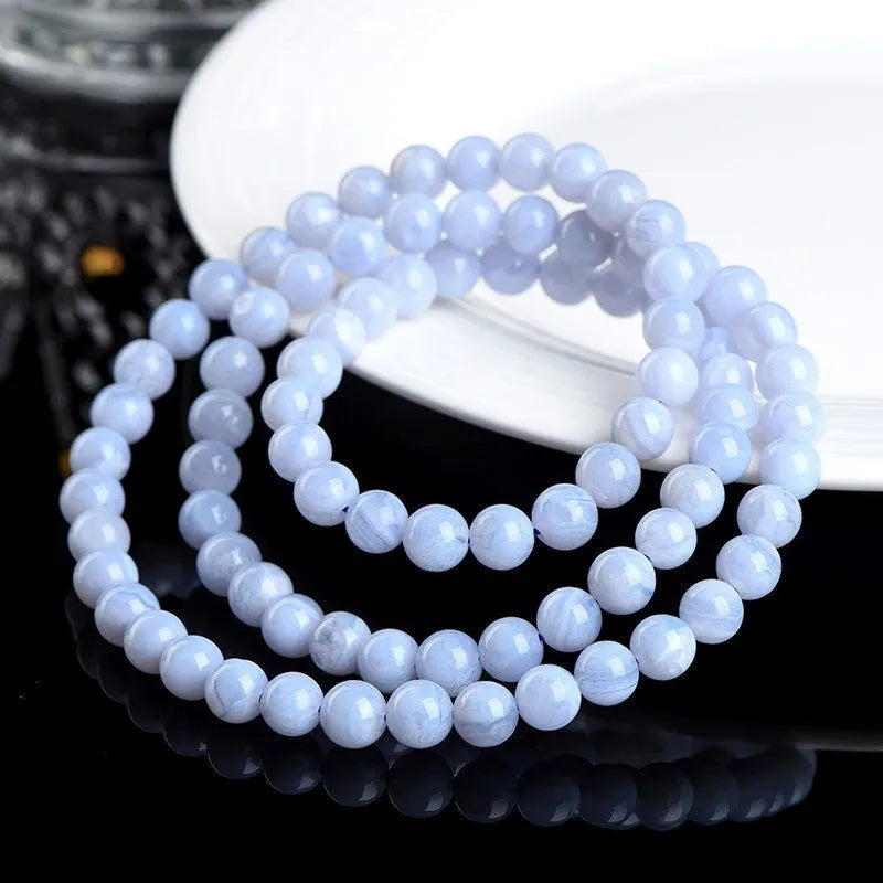 Close-up of a blue multi-circle patterned agate bead bracelet with 6-6.8mm beads and ruyi decorative elements.