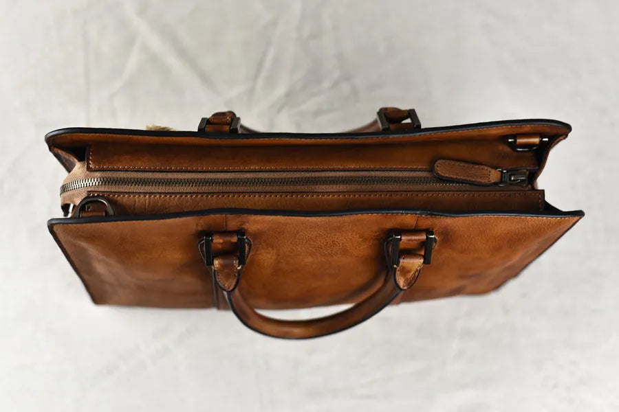 Men's brown leather business handbag with square horizontal shape and top zipper opening
