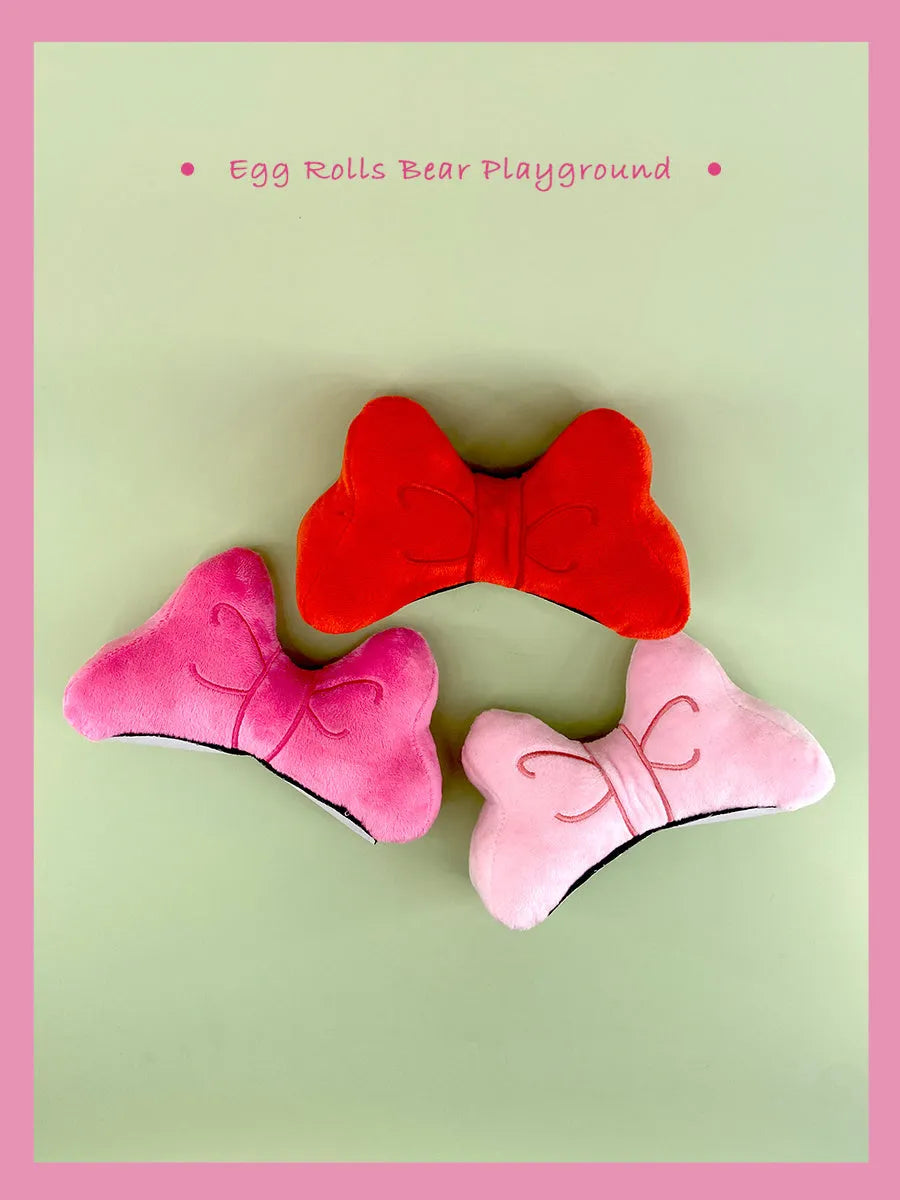 Soft plush decorative bow tie for electric motorcycle and ski helmets in red, peach pink, or rose pink colours