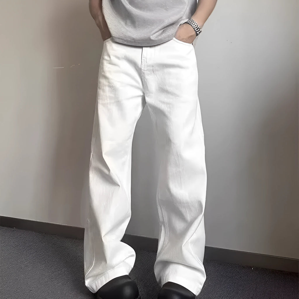 Men's white straight-leg denim jeans on a neutral background, showing mid waist and loose fit.