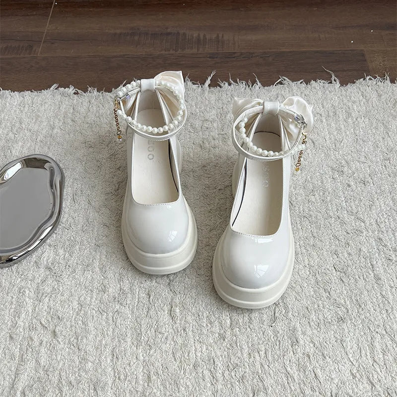 Women's beige and black chunky heel Mary Jane pumps with round toe and shallow cut.