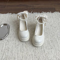 Women's beige and black chunky heel Mary Jane pumps with round toe and shallow cut.
