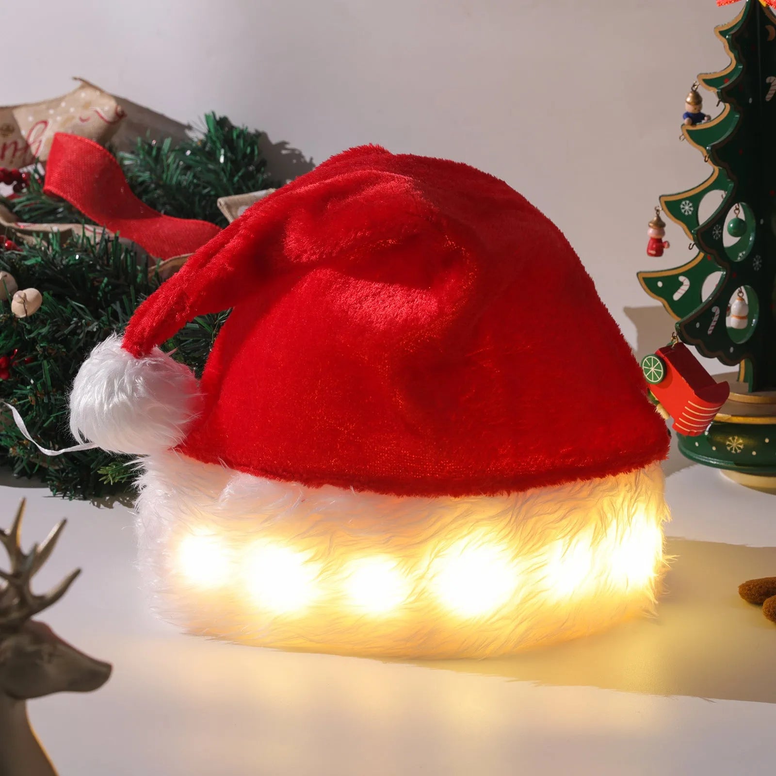 Red and white plush Santa hat with white pom-pom and 20 glowing LED lights on the brim.
