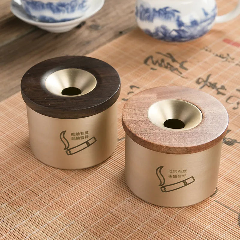 Brass ashtray with wooden lid featuring centre hole design