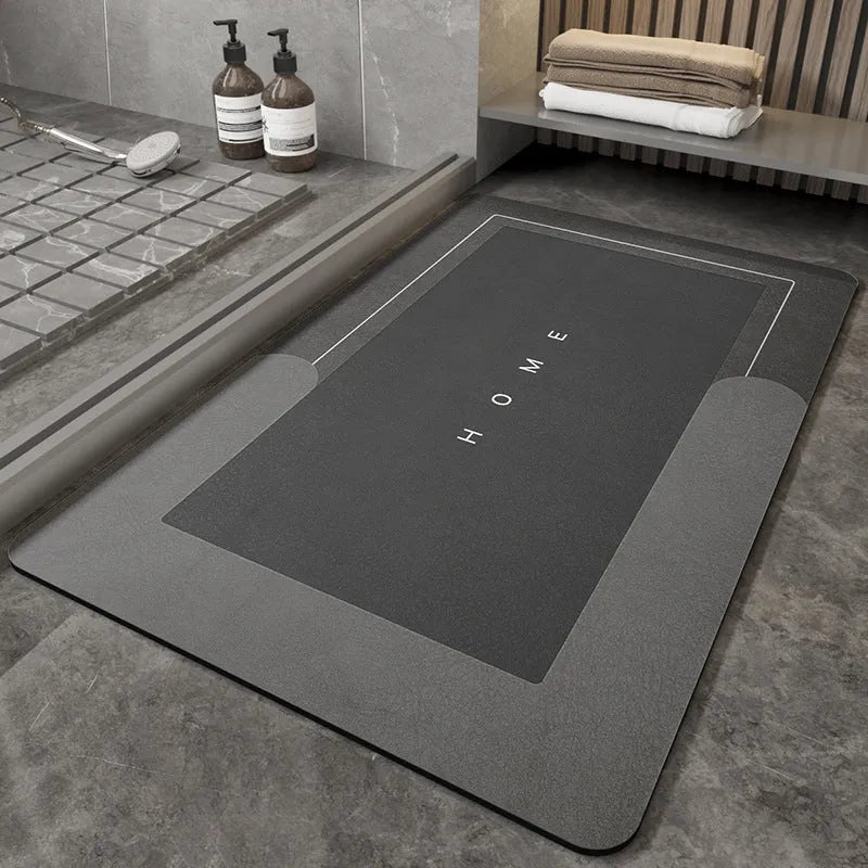 Blue oval blended fabric bathroom floor mat placed on tiled floor.
