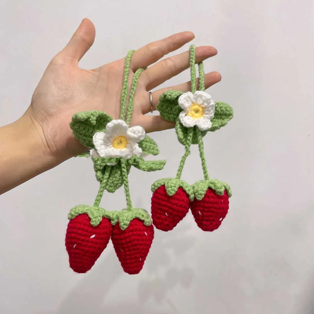 Handmade woven strawberry pendant decoration for car or keychain with lily of the valley hook.