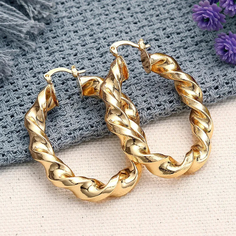 Geometric drop-shaped women's ear clip with ring design in electroplated copper.