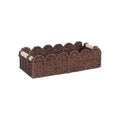 Modern simple woven paper storage basket in neutral colour on a wooden desktop holding remote controls and pens.