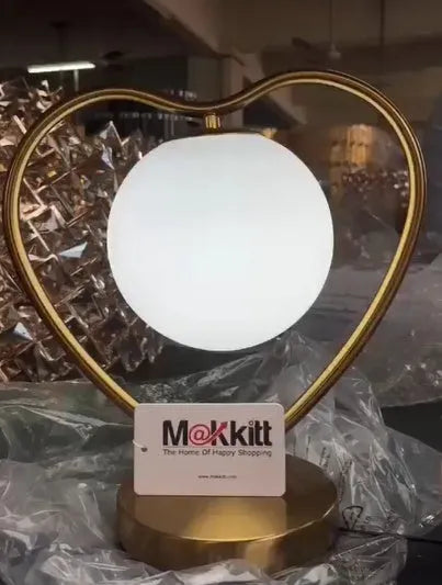 White heart shaped bedside table lamp with warm LED light and USB charging port.