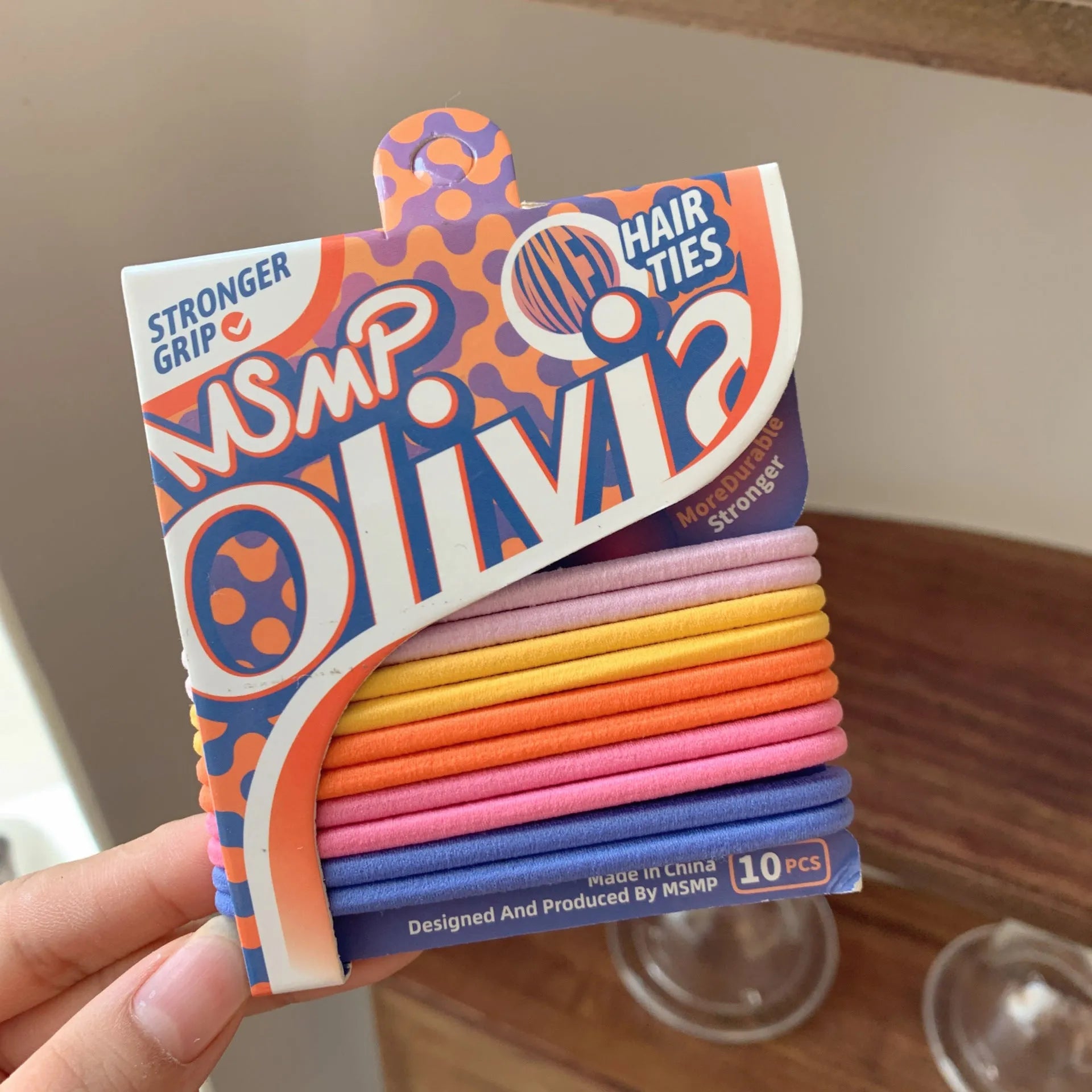 Assorted candy colour braided elastic hair bands for ponytails on a white background.