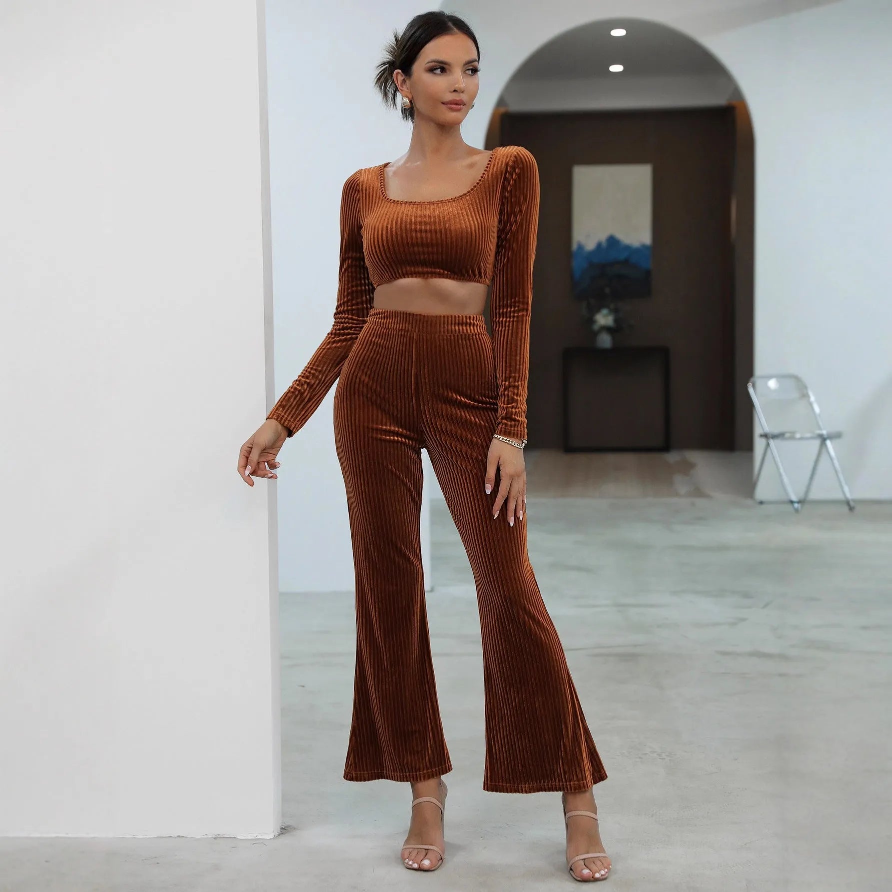 Caramel-colour long sleeve sweater and matching trousers casual set on a hanger.